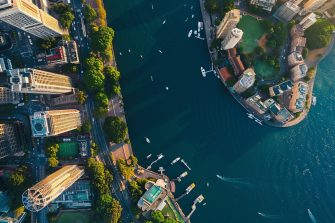 June 20, 2020. Sydney, Australia. Amazing aerial sunset view of the Sydney Opera house from above with Harbour bridge and the bay.