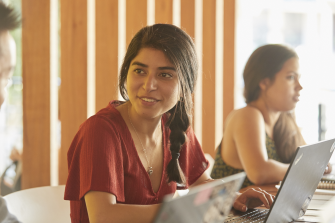 Students relaxing with computers, talking and studying at Kensington UNSW