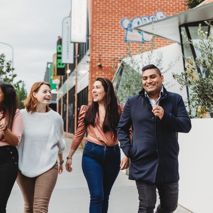 A group of students walk down Lonsdale Street in Braddon