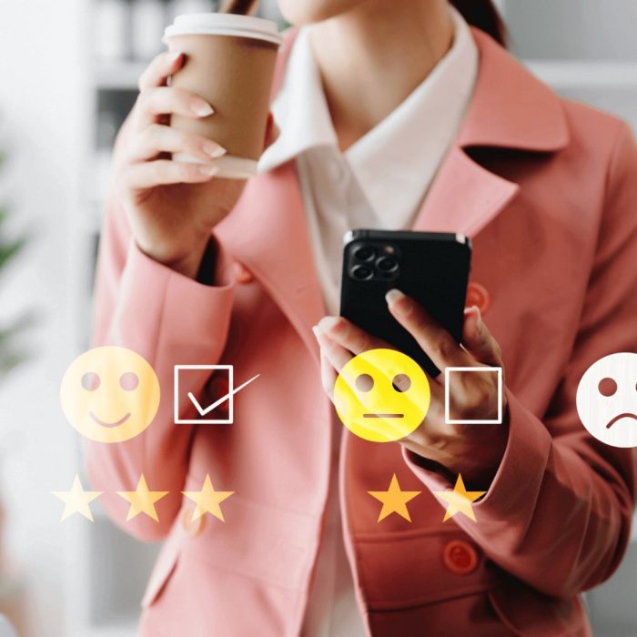 Woman in pink suit, coffee in one hand, mobile in the other, rating stars and faces overlay