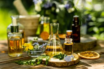 Alternative green herbal medicine. Natural plant-based ingredients for skin care beauty products, perfumery production. Small business, laboratory, drug research, organic extracts in glassware