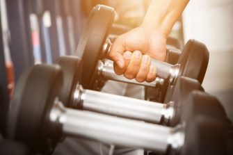 Hand lifting weights at the gym