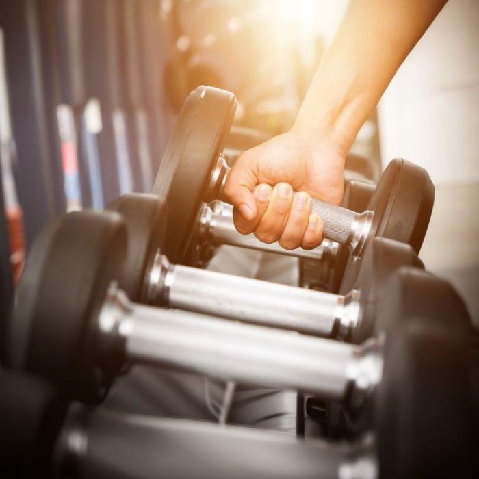 Hand lifting weights at the gym