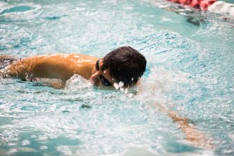 Student swimming laps in UNSW pool
