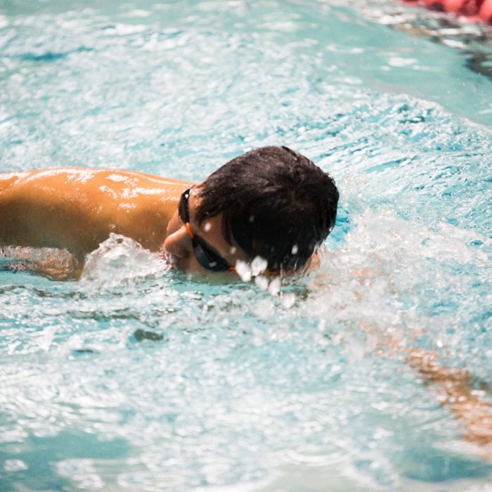 Student swimming laps in UNSW pool