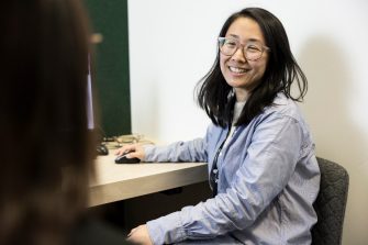 Student Advisor helping student at desk