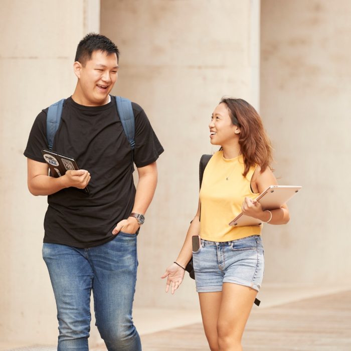 Couple of Students walking in L5 courtyard