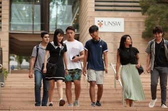 Students on walking down steps on campus