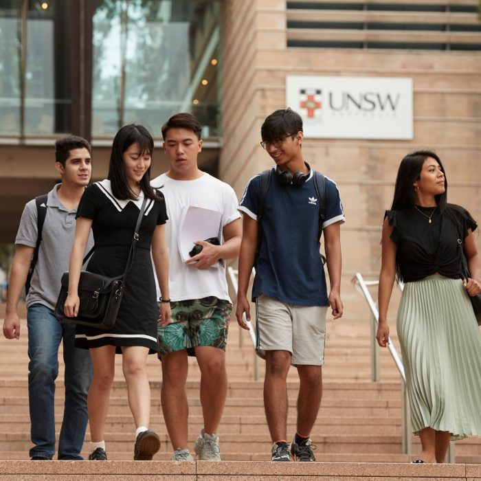 Students on walking down steps on campus