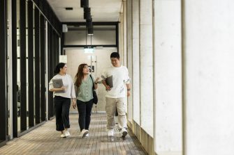Students walking and laughing in courtyard at L5