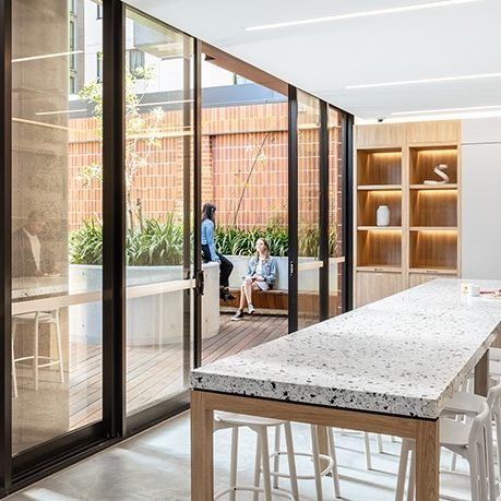 Students in kitchen and patio of Iglu Redfern accommodation