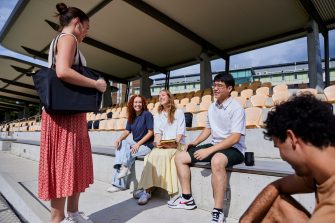 UNSW College students sitting outside, talking