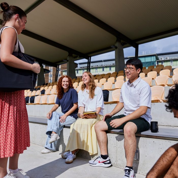 UNSW College students sitting outside, talking