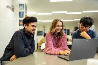 UNSW College students working on a laptop together