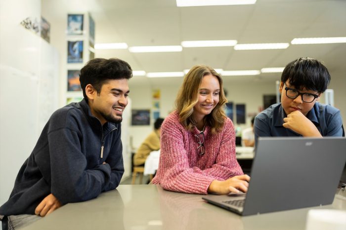 UNSW College students working on a laptop together
