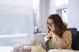 Student watching presentation on laptop