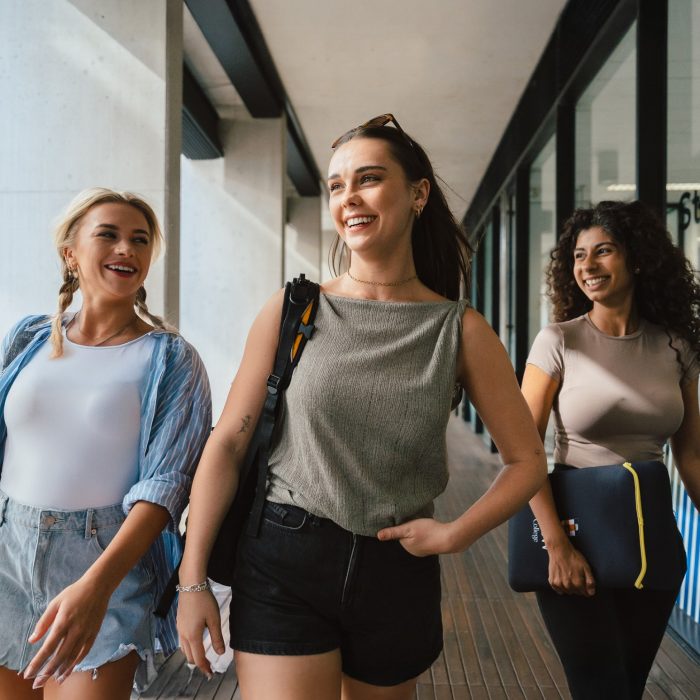 3 young women walking in the courtyard at UNSW College