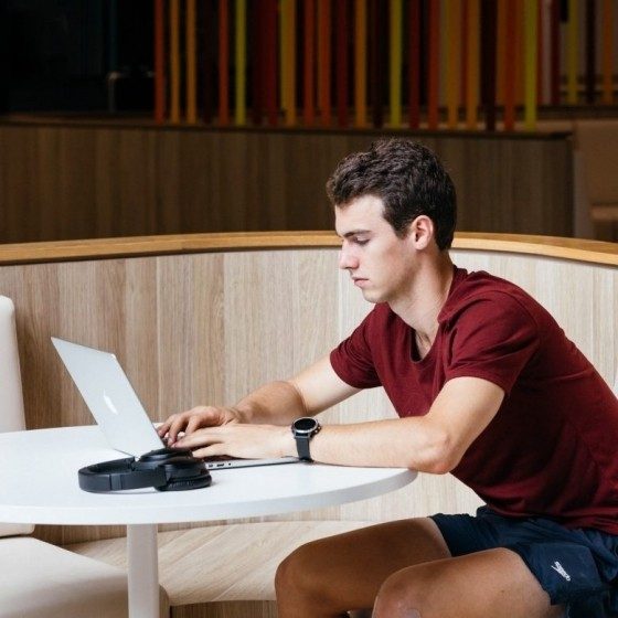 Photo of student using laptop on campus