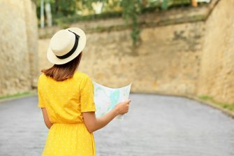 Young female tourist with map outdoors