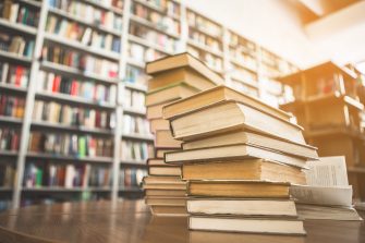 Library books stacked on a desk