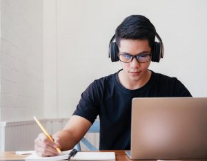 Student with headphones at computer